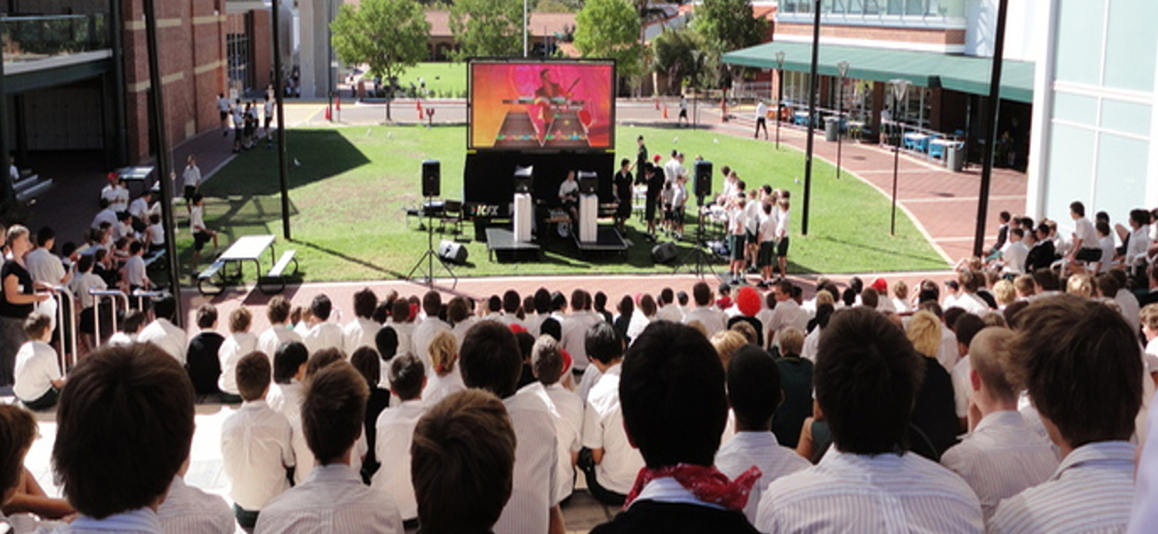 Students Watching the Guitar Hero Video Game Challenge